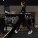 A woman demonstrates the Peloton Tread+ at CES 2018 in Las Vegas.